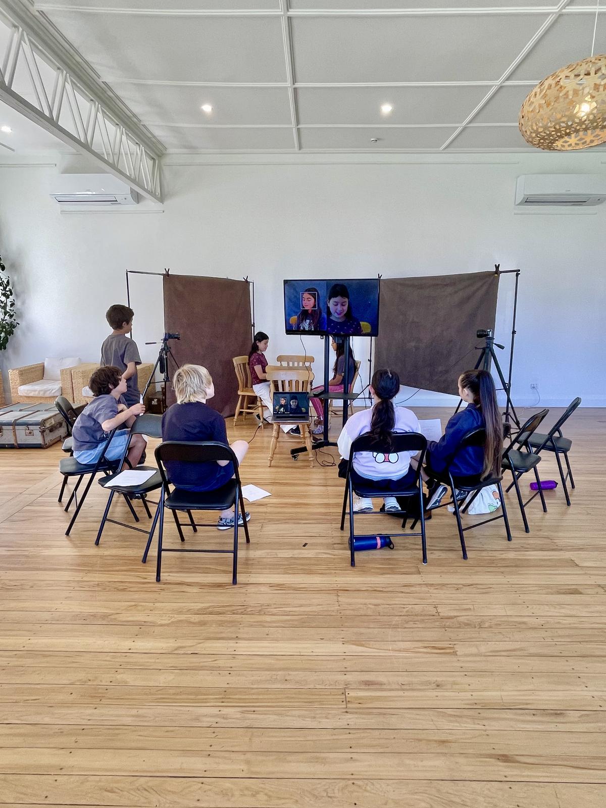 Child operating a camera in acting class